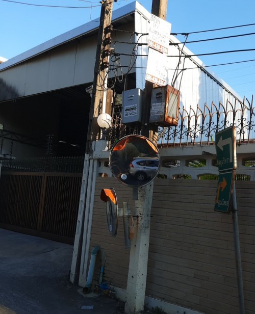 Parabolic mirrors are common in the narrow streets of some parts of Bangkok