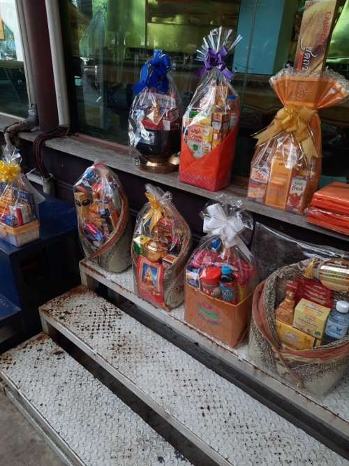 Donation bags with food, medicines or  personal care products for monks. They are paid for by the community.