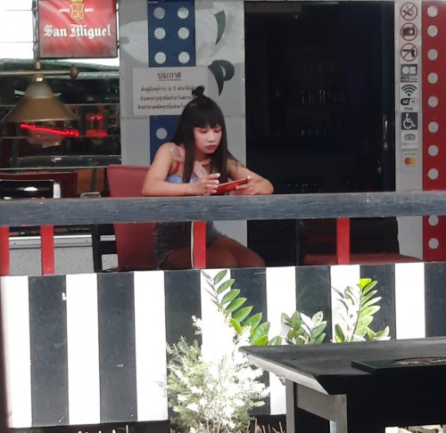 A bargirl plays on her mobile, waiting for customers that may not arrive any time soon.

As a result of the Covid pandemic in Thailand, foreign tourists have not visited the country since March 2020.