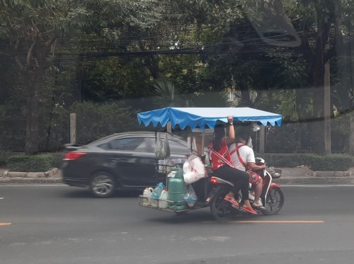 A common sight in Bangkok, a food tuktuk  braving the traffic.