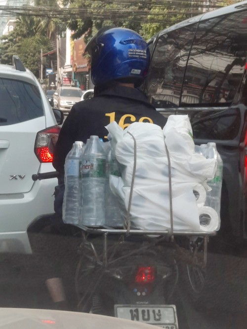 Motorcycle deliveries are a part of Bangkok's urban landscape.