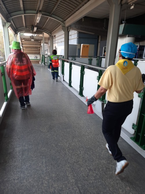 A cleaning crew disinfecting the entrace to a BTS station