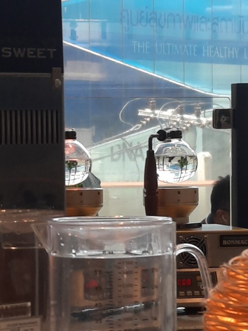 Refracted light on a couple of coffee syphons, Ekamai