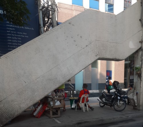 A mango seller waiting for morning customers coming off a BTS stairway. Nana.