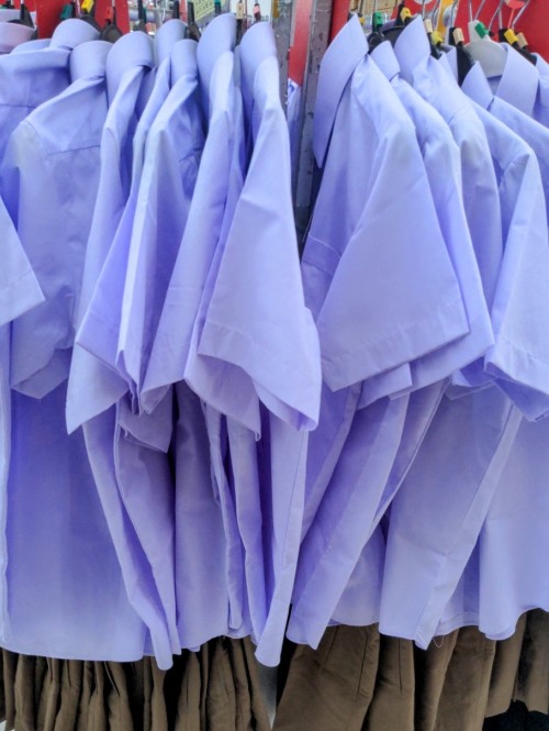 A rack of middle school uniforms for sale. Thailand has mandatory uniforms for all public education institutions, including university.