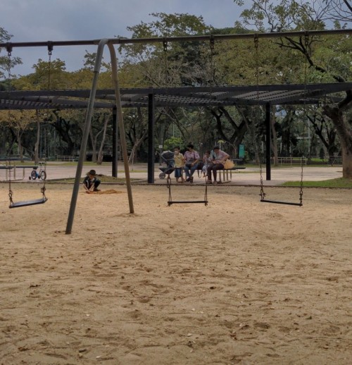 A child dogs in the sandpit on Lumphini park's playground. Open city parks were a welcome relief after months of lockdown.