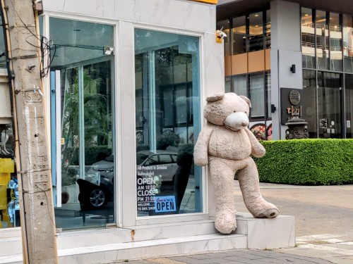 A six-foot teddy bear outside a children's clothing shop in Ekkamai.