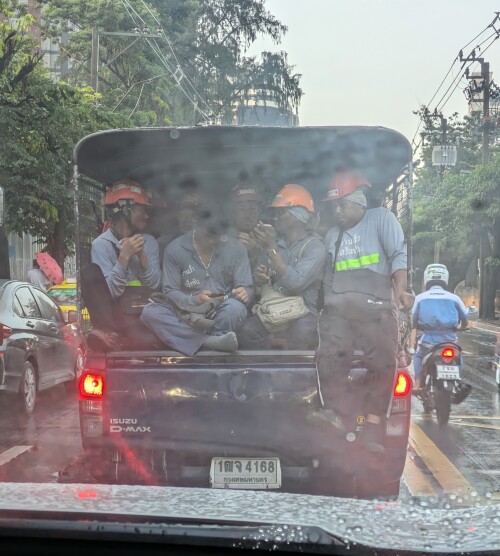 A construction crew commuting on a rainy afternoon